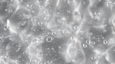 Hareket, sıvı krem jelin kabarcıklı şeffaf kozmetik dokusu. Organik kozmetik, ilaç. Üst Manzara. Yavaş çekim