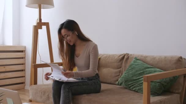 Middle Eastern female remote working from home, having a video call with colleagues, checking documents. Stay home, quarantine remote work. Slow motion. — Stock Video