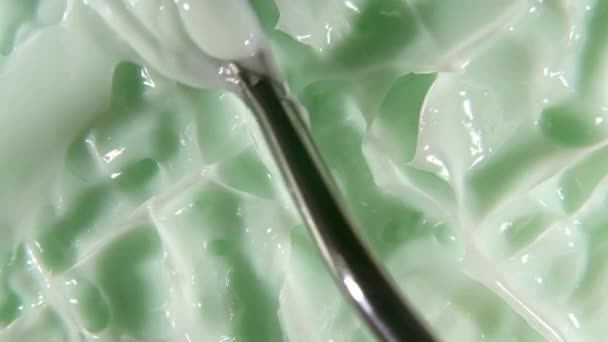 Motion of the juice aloe vera. Green liquid cream, cosmetic gel fluid rotation on a surface. Beauty skincare product sample with bubbles. Top view. Slow motion. — Stock Video