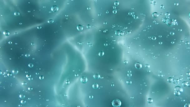 Blue serum texture, clear liquid gel background. Motion of the transparent beauty skincare product sample with bubbles. Top view. Macro Shot — Stock Video