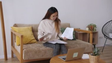 Orta Doğulu kadın uzaktan kumanda, iş arkadaşlarıyla görüntülü görüşme, belgeleri kontrol. Evde kal, uzaktan kumandayı karantinaya al. Yavaş çekim.