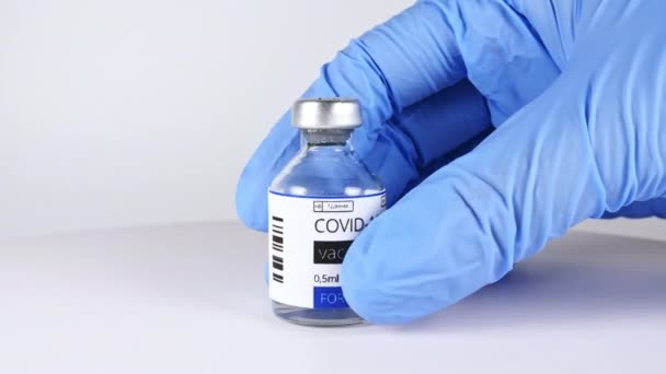 研究人员手中的COVID-19疫苗，医生将疫苗放在治疗大肠埃希菌的饭盒上. — 图库视频影像