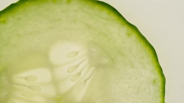 Macro Shot of Transparent Slice of Cucumber Fruit and Rotate. Closeup Fresh Cucumber. Healthy Food Background. Slow Motion. — Stock Video