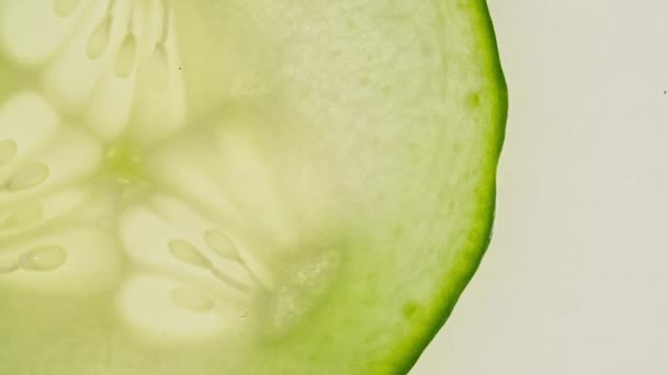 Macro Shot of Transparent Slice of Cucumber Fruit and Rotate. Closeup Fresh Cucumber. Healthy Food Background. Slow Motion. — Stock Video