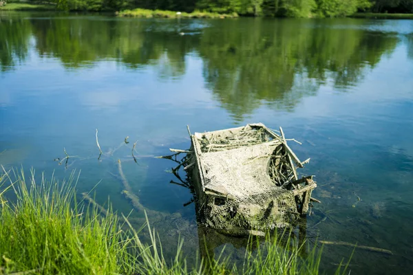 Broken box in lake — Stock Photo, Image