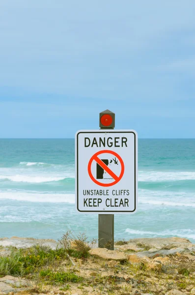 Warning sign danger unstable cliffs keep clear rural coast line