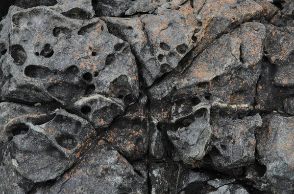 Texture holes  in rough rock surface — Stock Photo, Image