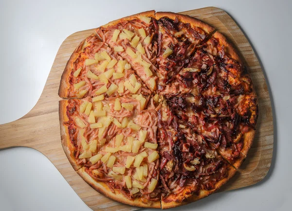 Half and half pizza on wooden base