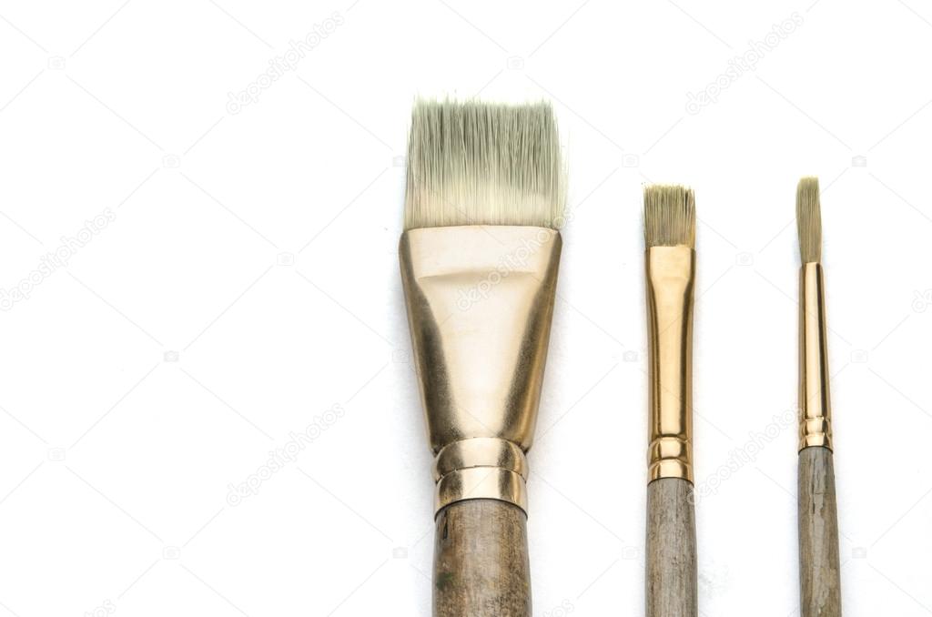 Three art paint paint brushes on white 