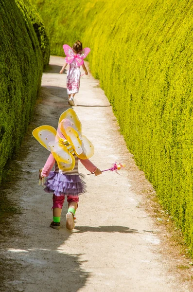 Two girls dress up faries run away — Stock Photo, Image