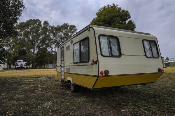 Retro caravan trailer at camping ground — Stock Photo, Image