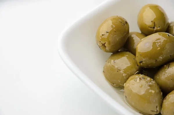 Green olives in white bowl — Stock Photo, Image