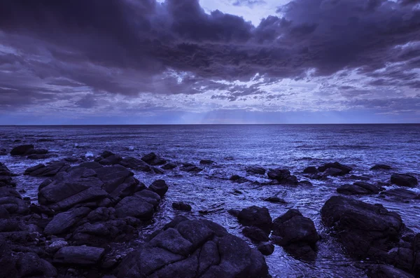 Pôr-do-sol dramático no oceano com rochas de pedra — Fotografia de Stock