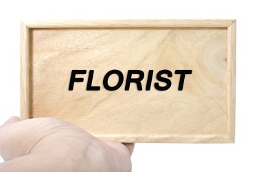 İş ve reklam kavramı. word çiçekçi ile düz ahşap tutan el