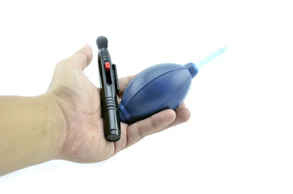 Lens pen and blue air blower on hand — Stock Photo, Image