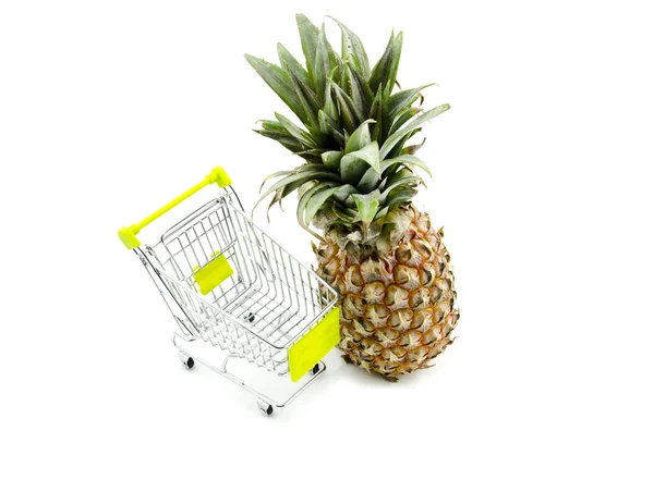 Shopping fresh pineapple with trolley  isolated white background — Zdjęcie stockowe