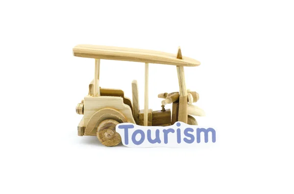 Handcrafted souvenir.thailand iconic transport,tuk-tuk  made from wood with word tourism — Stock Photo, Image