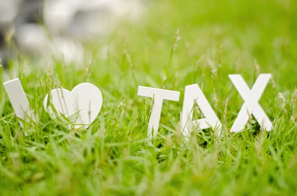 Closeup view white wood alphabet i love tax — Stock Photo, Image
