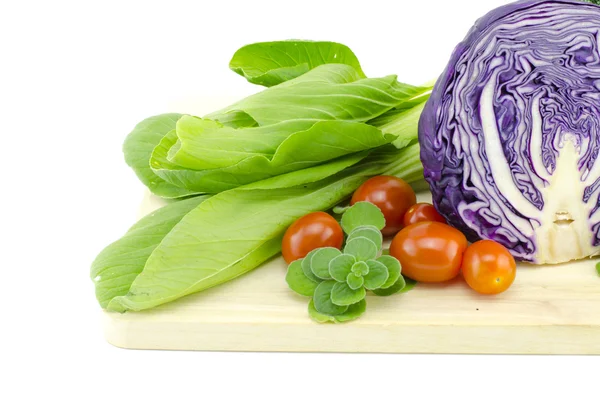 Fresh raw Bak Choi ( Chinese Cabbage), purple cabbage, cherry tomatoes and mint on wooden cutting board — Stock Photo, Image