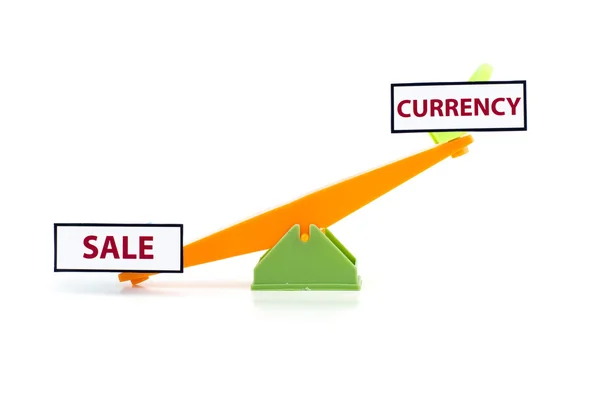 Image concept of unbalance word sale at bottom and currency on top.green and orange colour toy seesaw — 图库照片