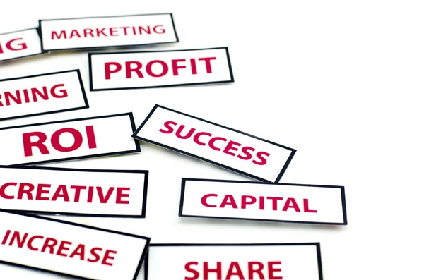 Business motivatie word hoofdstad, winst, Roi, Creative, succes en aandeel afgedrukt op papier — Stockfoto