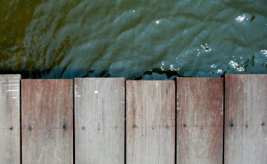 Top view of wood bridge and river in background