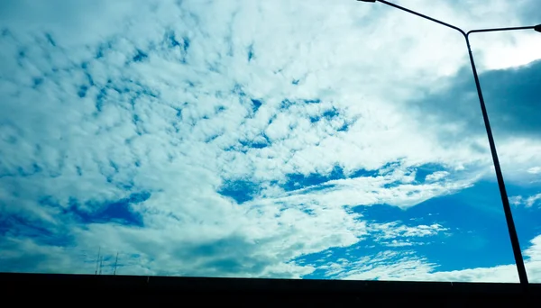 road lamp and blue sky with could silhouette