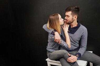 Photo of beautiful couple sitting and looking at each other