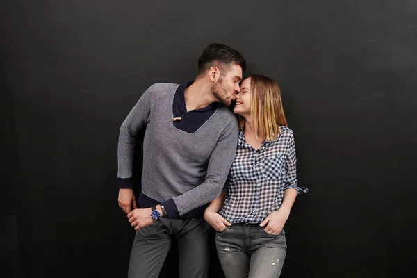 Young couple standing and kissing — Stok fotoğraf