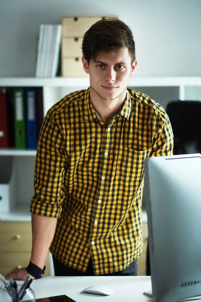 the young man behind the desk in the office