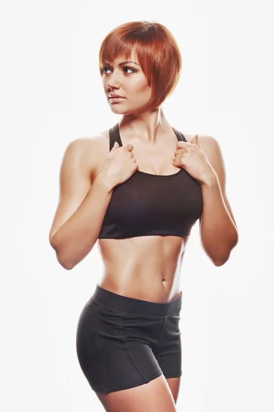 Porträt einer rothaarigen Frau in Sportbekleidung. Studioaufnahme — Stockfoto