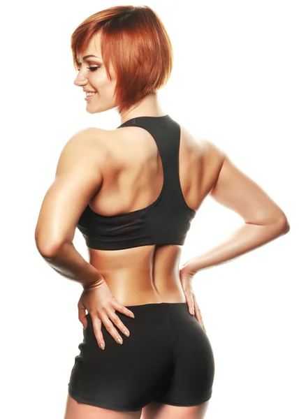 Back view of fit female athlete against of white background — Stock Photo, Image