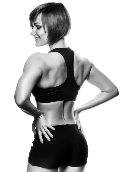 Visão traseira do atleta fêmea apto contra de fundo branco — Fotografia de Stock