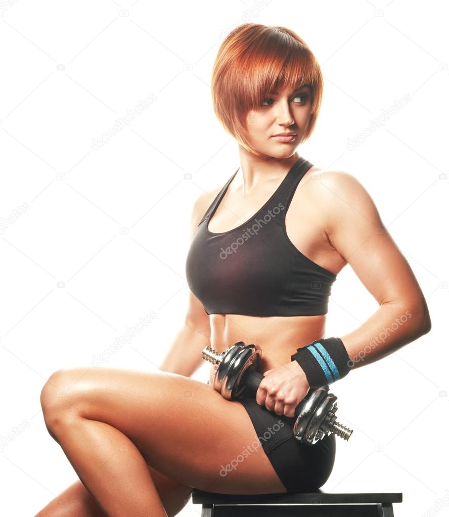 Portrait of redhead woman sitting and holding straps and workout