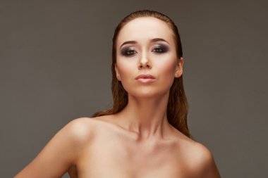 attractive slim girl in a swimsuit suit and sunglasses. studio 