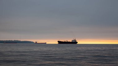 Looking at Vancouver (Kitsilano and UBC) from the North Shore at sunset, with freighters on the water at sunset, British-Columbia, Canada
