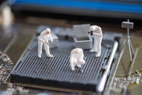 Miniature People: Worker professional checking technology inside old personal computer. maintenance concept, close up view.