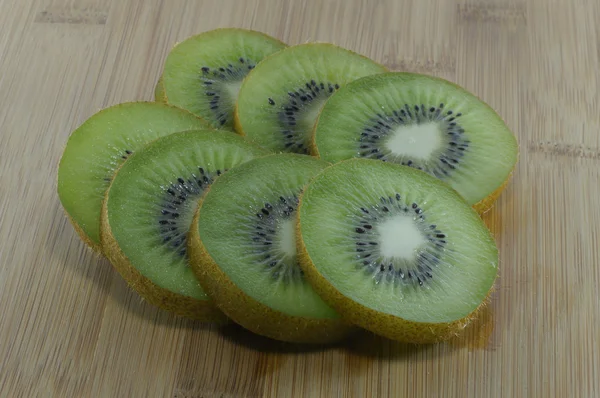 The kiwi fruit cut on a bamboo board — Stock Photo, Image