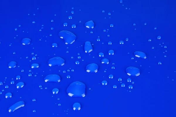 Photo of water droplets on a blue background — Stock Photo, Image