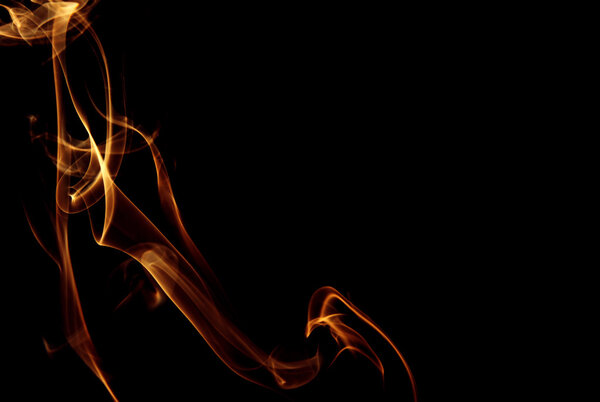 Hovering trail of smoke in gold and burgundy isolated on a black background, abstraction. Horizontal view.