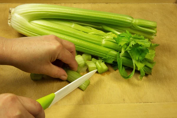 Slicing fresh celery on the old kitchen pastry board