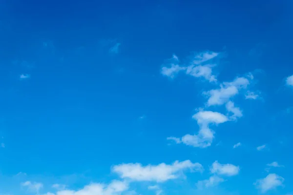 Beyaz bulutlar açık mavi gökyüzüne karşı.