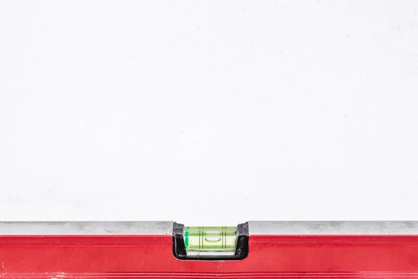 Kırmızı bina seviyesi, beyaz arkaplanda yan görünüm, metin için boşluk ile izole.