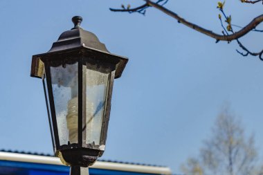 Güneşin altında sıcak bir yaz gününde klasik sokak lambası.