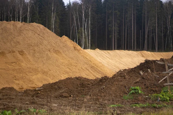 Construction sand. A mountain of sand on a construction site.