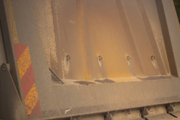 Rear door of a truck. Truck body. Yellow side wall of the container for the transfer of goods.