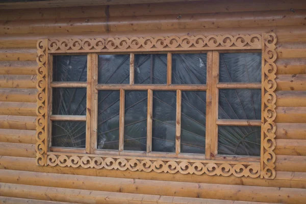 Wooden window with platband. Patterned platband made of wood — Stock Image Wooden window with platband. Patterned platband made of wood Royalty Free Stock Images