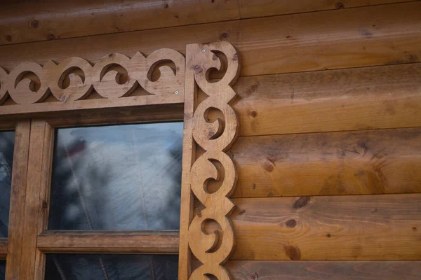 Wooden window with platband. Patterned platband made of wood — Stock Image Wooden window with platband. Patterned platband made of wood Stock Picture