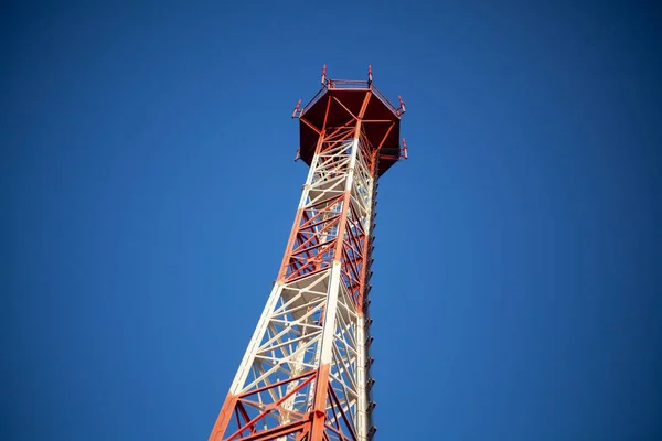 Telephone tower. Radio. The tall tower is red and white. Signal transmission device. View of the tower from below. — Stock Photo, Image