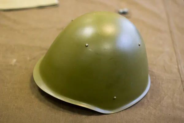 Military helmet of a Soviet soldier during the Second World War. Green safety helmet for the head. The helmet protects the head from shots.